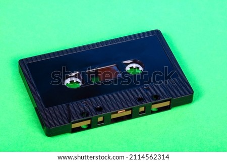 Vintage retro audio cassette tape isolated on a green background
