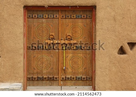 old heritage door form al khabra old city Saudi Arabia riadh with  measuring tools Royalty-Free Stock Photo #2114562473
