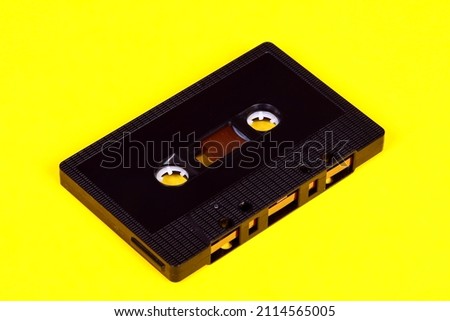 Vintage retro audio cassette tape isolated on a yellow background