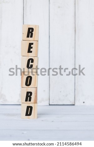 wooden cube, with the word record, with white wooden background