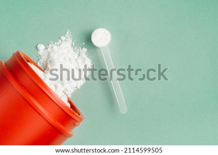 creatine powder vitamin and sports supplement concept over isolated background. Royalty-Free Stock Photo #2114599505