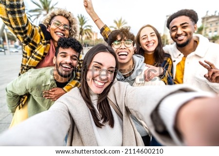 Multiracial group of friends taking selfie picture with cellphone in city street - Millenial people standing together laughing at camera outside - Happy tourists enjoying holiday day on summer time 