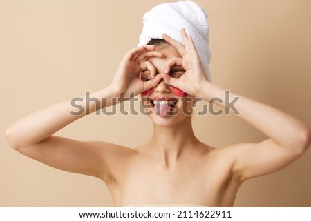young woman with a towel on his head gesturing with his hands skin care beige background