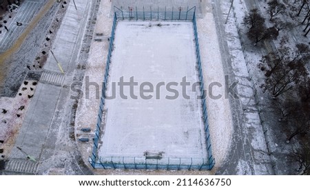 Snow football pitch. Football field top view in the winter filming on drone