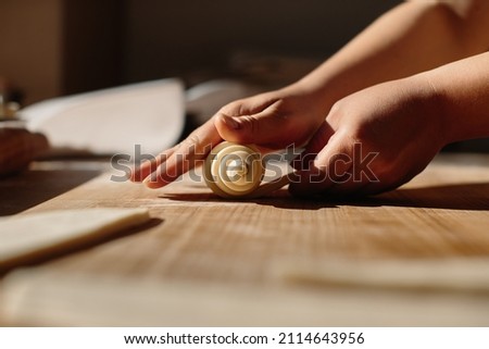 Female Hands Rolling Dough into Rolls, Baking Process Making Croissant. Selected Focus, Concept for Bakery Royalty-Free Stock Photo #2114643956