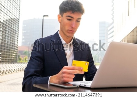 Businessman shopping online with a Bitcoin credit card. Bitcoin card concept.