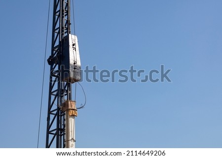 Mobile derrick pile red driving is installing concrete pile I-shape ready for work driven friction pile drop hammer in foundation work and construction of building Royalty-Free Stock Photo #2114649206