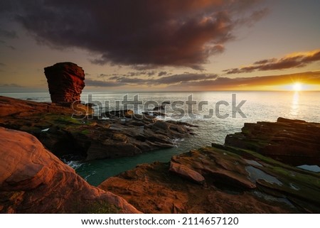 Sunrise view of the coastline at Arbroath, Angus Scotland.  Royalty-Free Stock Photo #2114657120