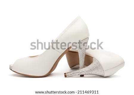 Ivory female wedding footwear isolated over white background Royalty-Free Stock Photo #211469311