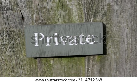 Wooden sign saying the word Private attached to wooden background