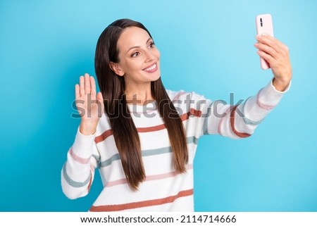 Photo of friendly cute pretty blogger lady take phone selfie wave hand wear striped sweater isolated blue color background