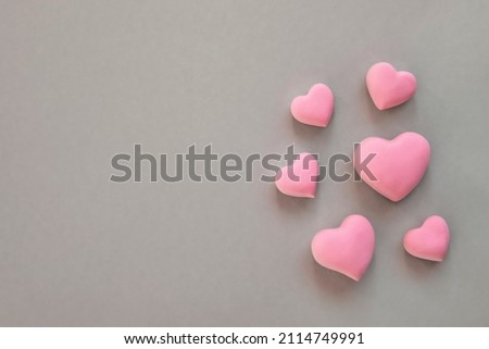 3d pink hearts creative arrangement on neutral background. Concept of love, romantic relationship, heart shape symbol, simple layout, celebration of  wedding, Valentine's Day border background.