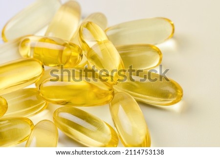 Close up of  oil filled capsules suitable for: fish oil, omega 3, omega 6, omega 9,  vitamin A, vitamin D, vitamin D3, vitamin E  Royalty-Free Stock Photo #2114753138