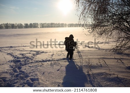 photographer at work in the winter in the field
