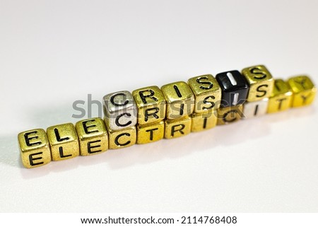 Covid crisis word consisting of letter cubes placed on the word electricity crisis.White background.