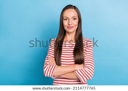 Photo of young attractive woman good mood folded hands smart leader isolated over blue color background