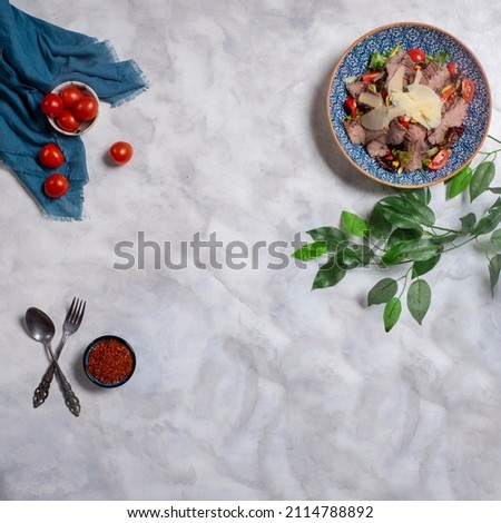 Delicious salad, Beef salad with cheese, food styling, top view decorative table
