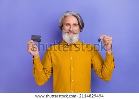 Photo of aged man purchase new apartment bank card savings moving real estate isolated over violet color background