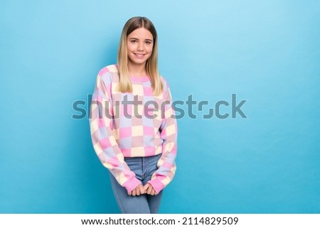 Portrait of attractive shy modest cheerful girl posing copy space isolated over vibrant blue color background