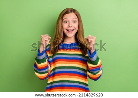 Portrait of attractive amazed funny girly cheerful lucky girl having fun rejoicing isolated over bright green color background