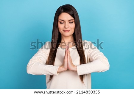 Photo of young lovely woman practicing dreamy relax yoga waiting isolated over blue color background
