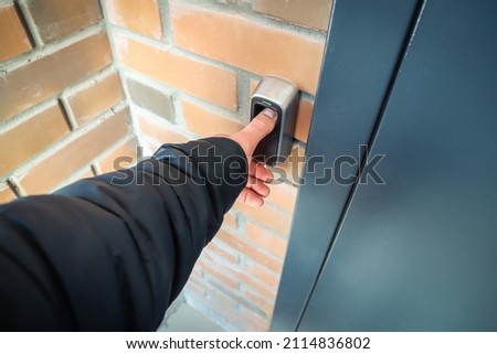 Device for scanning fingerprint. Residential building entrance. Brick wall