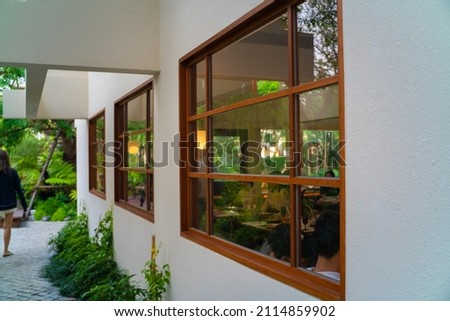 Modern wood window of garden house with tree luxury house in city