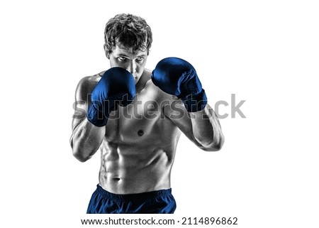 Half length of professional athlete boxer in blue gloves who isolated on white studio background. Fit muscular caucasian athlete fighting. Sport, competition concept. Black and white silhouette  Royalty-Free Stock Photo #2114896862