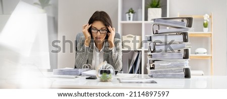 Bored Workaholic Accountant Businesswoman At Office Desk Royalty-Free Stock Photo #2114897597