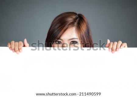 Close up Asian woman hold a blank sign close her lower face on gray background