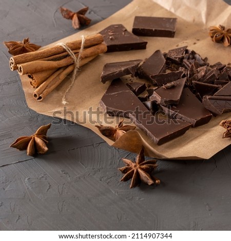 broken chocolate with anise and cinnamon sticks. horizontal composition