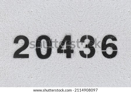 Black Number 20436 on the white wall. Spray paint.two thousand four hundred thirty sixtwo thousand four hundred thirty six