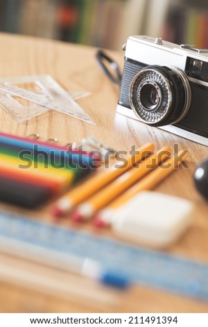Some school supplies, ready to back to school, focus on vintage camera.