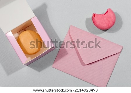 macarons cake in gift box and mockup letter on a grey background, St. Valentines day concept