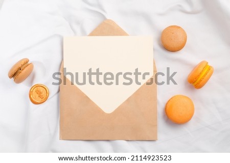 Colorful macarons and mockup letter on white textile, St. Valentines day concept