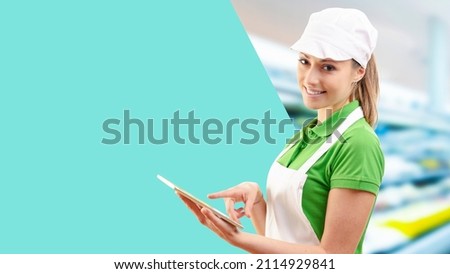 Smiling grocery shopping assistant using a digital tablet, blank copy space