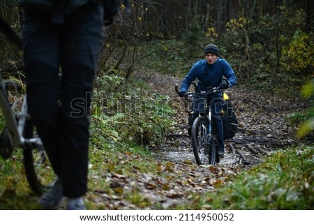 Russian bicyclist in the autumn forest, Moscow Region