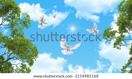 white doves flying in the sky. green tree leaves and sunny sky. bottom-up view. stretch ceiling decoration picture.