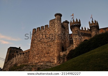 Castle with towers and battlements on a hill at dusk Royalty-Free Stock Photo #2114982227