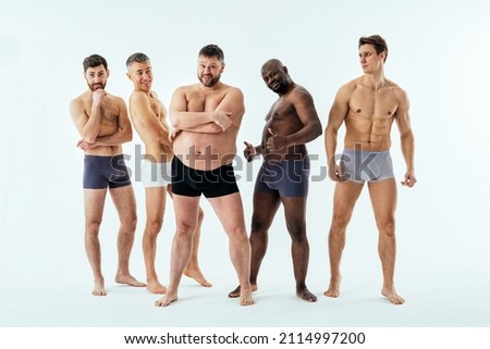 Group of multiethnic men posing for a male edition body positive beauty set. Shirtless guys with different age, and body wearing boxers underwear Royalty-Free Stock Photo #2114997200