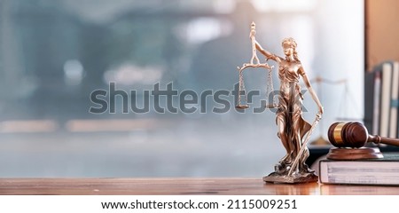 Legal and law concept. Statue of Lady Justice with scales of justice and wooden judge gavel on wooden table. Panoramic image statue of lady justice. Royalty-Free Stock Photo #2115009251