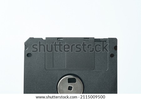 detail of old black 1.44Mb floppy disk on white background
