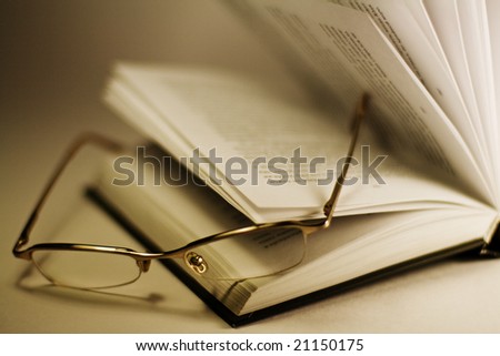 closeup of opened book and glasses