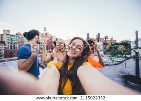 Storytelling image of a group of teenagers making party on a rooftop in New york city. Concept about lifestyle and youth