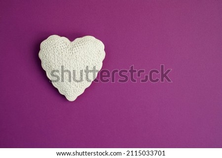 White heart on violet purple background. Valentine's day, anniversary, mother's day, marriage concept, invitation e-card. Copy space for text