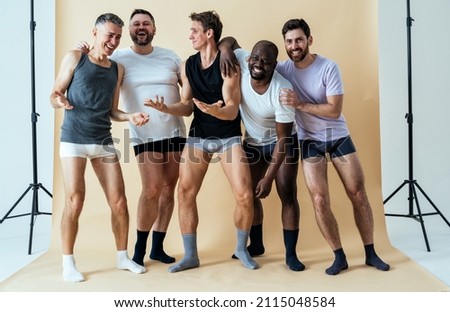 group of multiethnic men posing for a male edition body positive beauty set. guys with different age, and body wearing boxers underwear