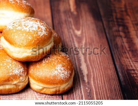Austrian and german donuts or krapfen.  Berliner with cream. On wooden background. Selective focus.