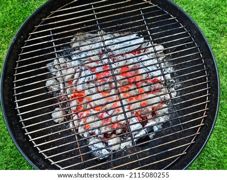 Empty grill grate over hot pieces of coals. Top view.