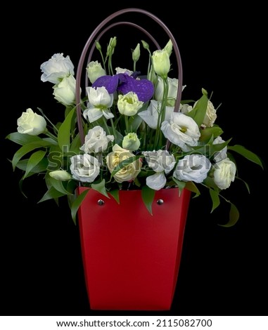 Postcard picture of a bouquet of roses, iris in a red paper box basket isolated on a white background close-up.