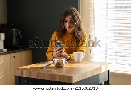 Girl working at home with a iPhone 13 pro during quarantine